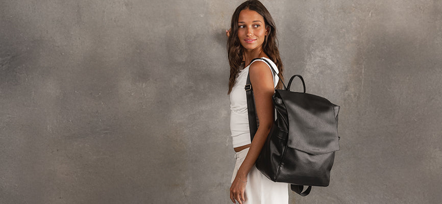 Black Backpack hangs from young woman's shoulder