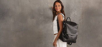 Black Backpack hangs from young woman's shoulder