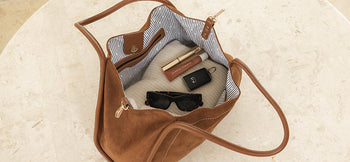 Louenhide Tote Bag is open showing sunglasses, lipgloss, keys and jumper inside