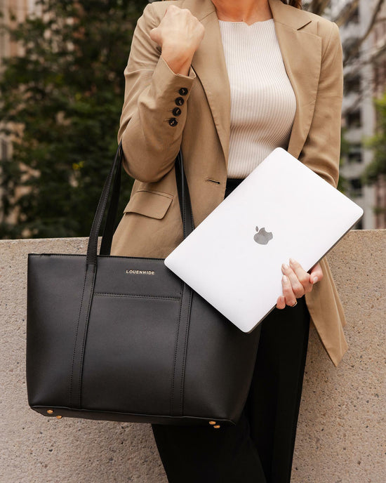 Louenhide Malibu Laptop Bag in black vegan leather styled with blazer and Macbook for work