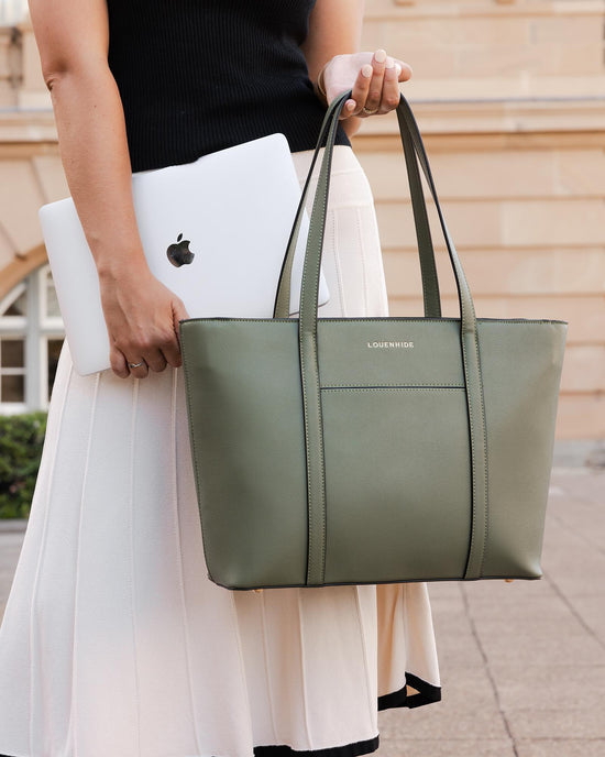 Louenhide Malibu Laptop Bag in sage green vegan leather is styled with Macbook, skirt and top for work