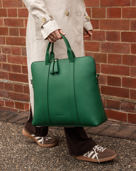 Louenhide Rhodes Green Laptop Bag paired with sneakers and coat