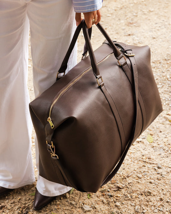 Louenhide Boston Weekender Travel Bag in Chocolate, close-up of the vegan leather of the chocolate brown weekender travel bag.