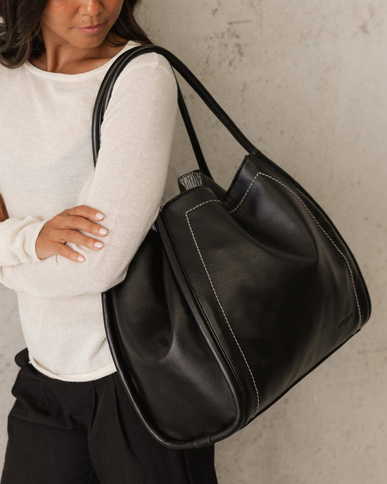 Louenhide Sutton Shoulder Bag in Black features contrast stitching against soft vegan leather