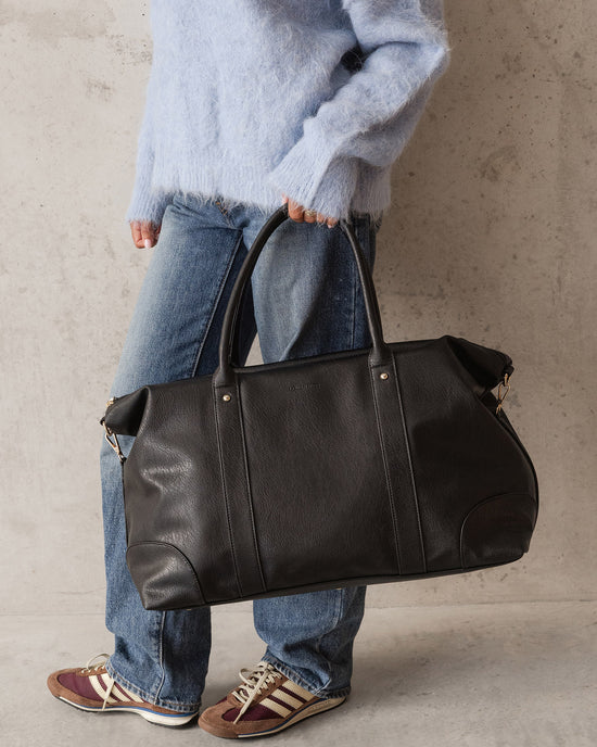 Louenhide Alexis Weekender Bag in Black styled with casual denim for a weekend escape