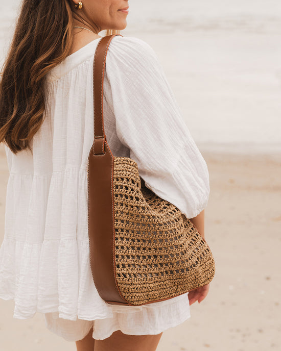 Louenhide Louisa Shoulder Bag styled with white cotton blouse on beach