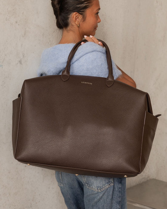 Louenhide Ohio Overnight Bag in Chocolate slung over shoulder ready for a weekend away
