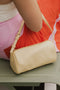 Butter Yellow Serena Handbag dangles from woman's arm